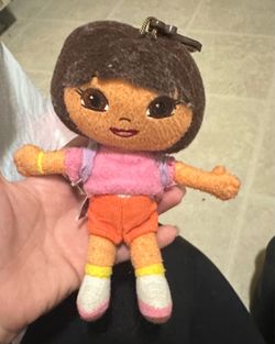 Tiny Dora plush with backpack and map