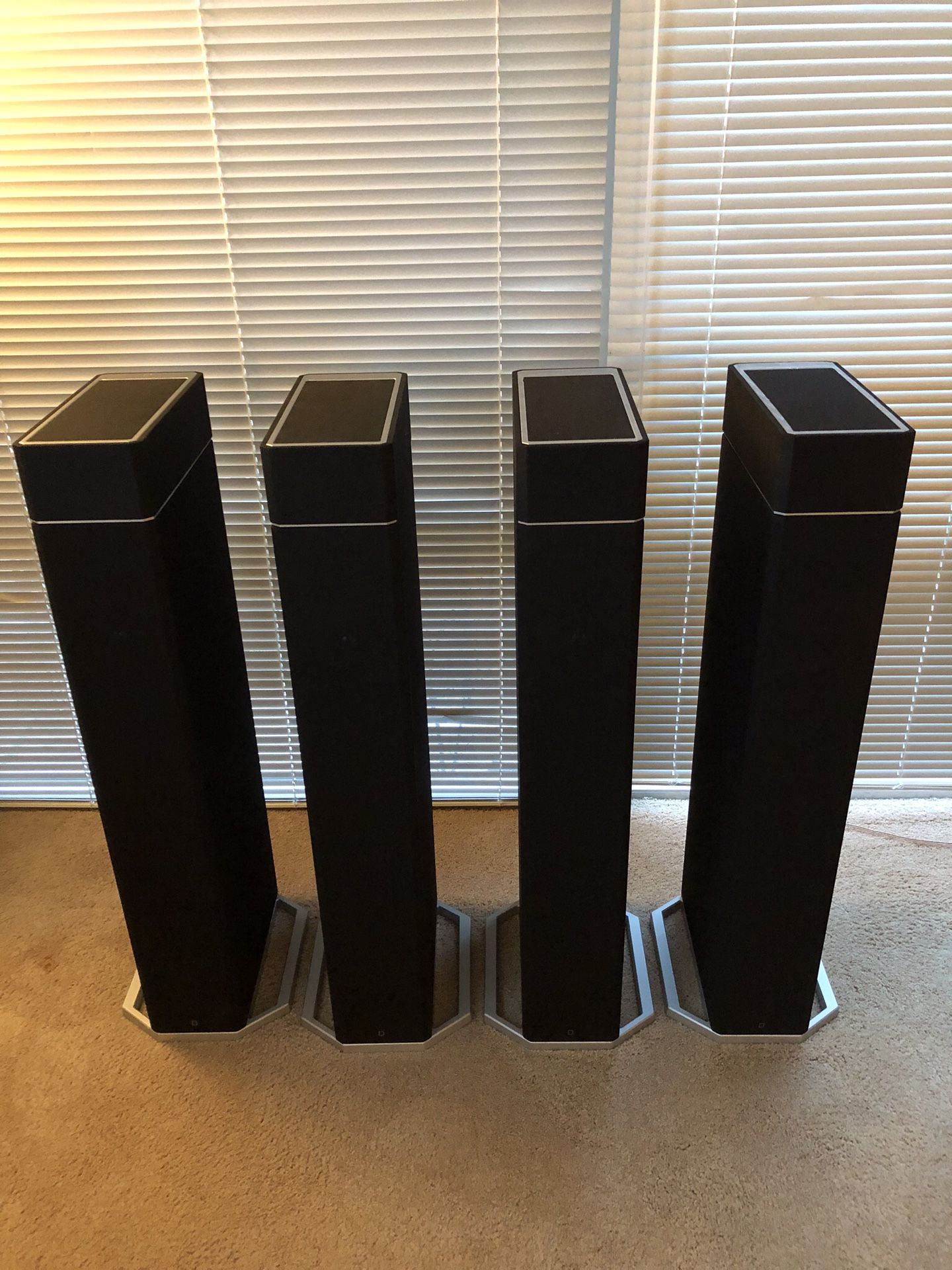 Four Definitive Technology BP9020 home theater speakers with A90 Dolby Atmos tops.