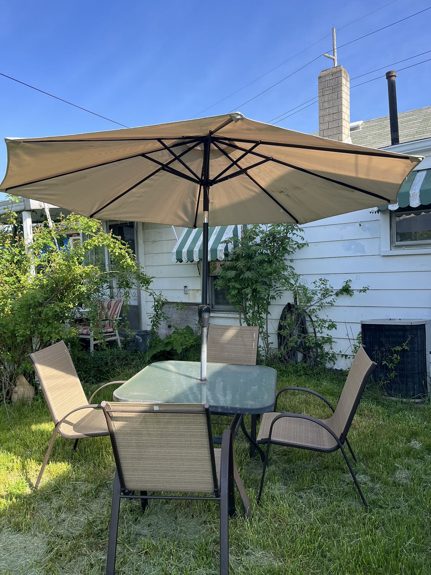 Patio Table, Umbrella, Four Chairs. 