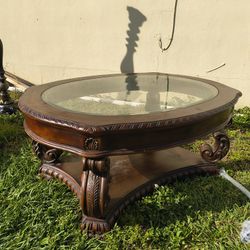 Coaster Home Furnishings Garroway oval coffee table with a glass inlay top and a brown finish. 