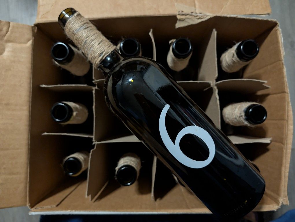 Empty Wine Bottles With Twine Used For Table Numbers