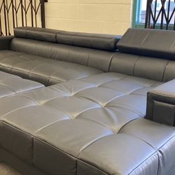 New Modern Sectional W Adjustable Headrests .  Large Ottoman .  Black Leather .  117” X 69”.  Free Delivery !
