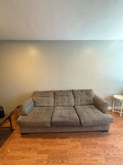 Free couch, small stains and tiny hole ass seen in photo