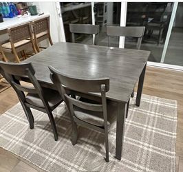 Grey dining room table with 4 chairs