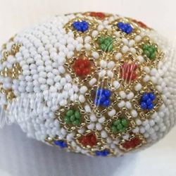 Decorative (Easter) Beaded Hungarian Egg.  Sparkles w/ Red, Green, Blue and Gold, on a white background.
