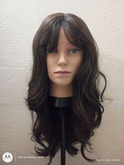 Dark brown synthetic wig with bangs and layers that are curl