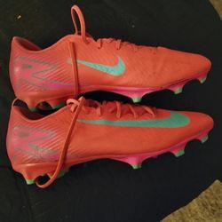 2 Pair Of Cleats And A Pair Of Timberland Boots