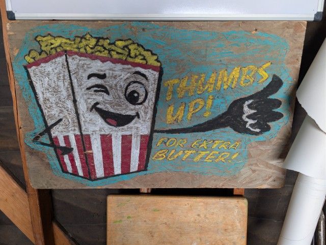 hand drawn and painted movie night wood sign