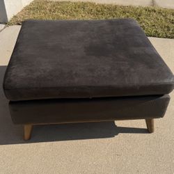 selling a large brown pouf/ottoman.