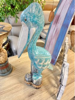 New handcrafted carved pelican on triple post