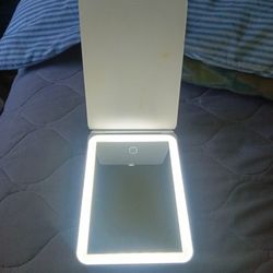 This Is A Portable Mirror With Three Different Settings On The Light Touch Tone