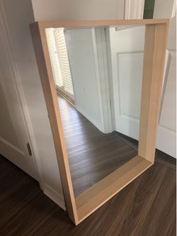 Light wood framed wall mirror