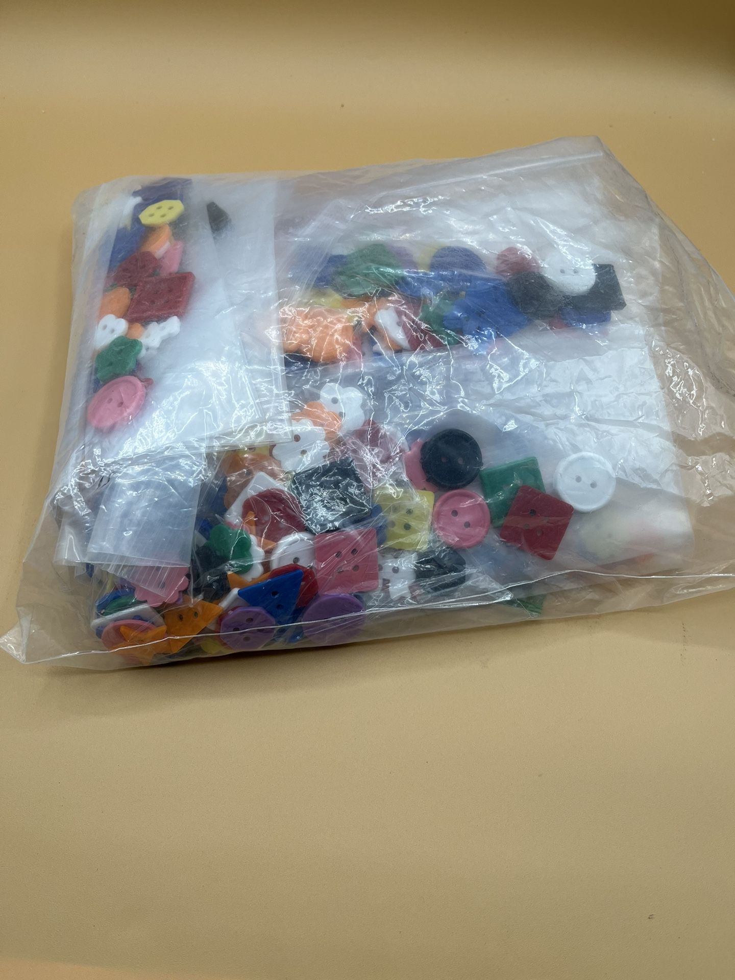 Assortment Of Colorful Plastic Buttons In Various Shapes And Sizes