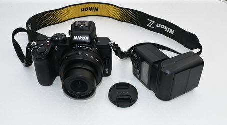 Nikon Z50 mirrorless camera with Nikkor 16-50mm lens, flash and accessories.