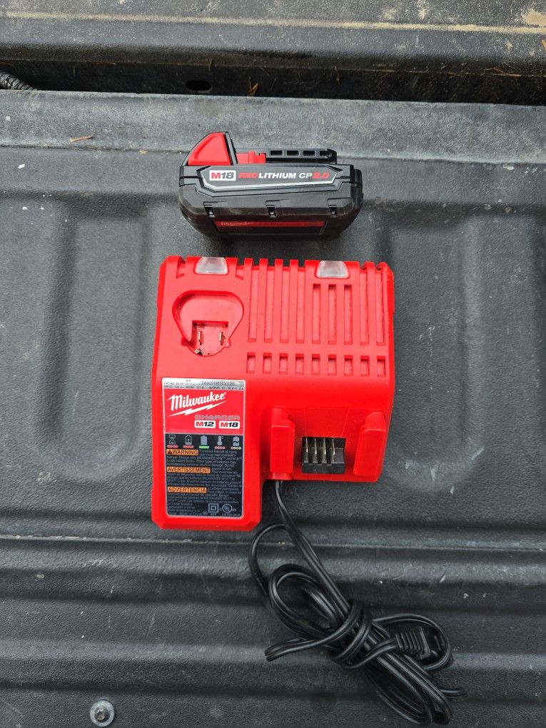 MILWAUKEE 12/18V CHARGER AND 1 2.0 BATTERY  PERFECT CONDITION 