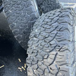 BF Goodrich All Terrain tires and factory rims with black wheel covers