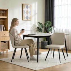 Set of 2 beige faux leather dining chairs, with black metal legs