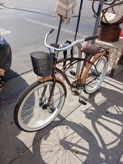 brown Huffy 26" Nel Lusso men's cruiser bike with a basket and rear rack.