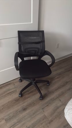 Black mesh office chair with lumbar support cushions