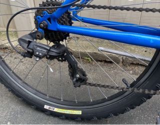 This is a blue and black Nishiki Men's Pueblo Mountain Bike with 26-inch wheels