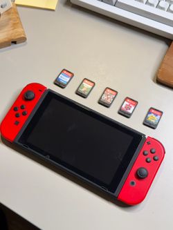 Nintendo Switch V1 with red Joy-Cons, HDMI cable, grip and case