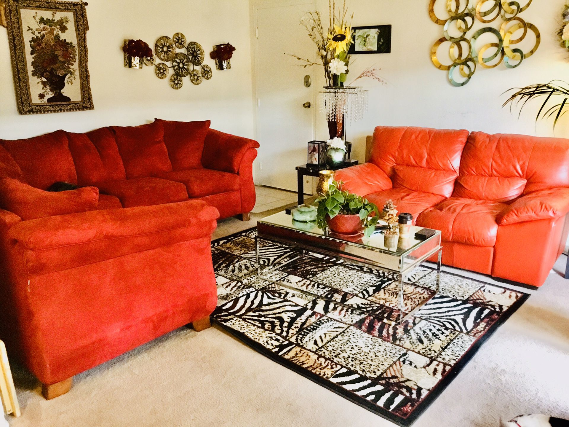 Beautiful Red Couch and leather loveseat and table Rug and Fireplace and TV