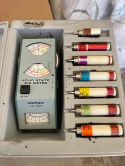 vintage Heathkit HD-1250 Solid-State Dip Meter inside its hard plastic storage case with an included set of plug-in coils