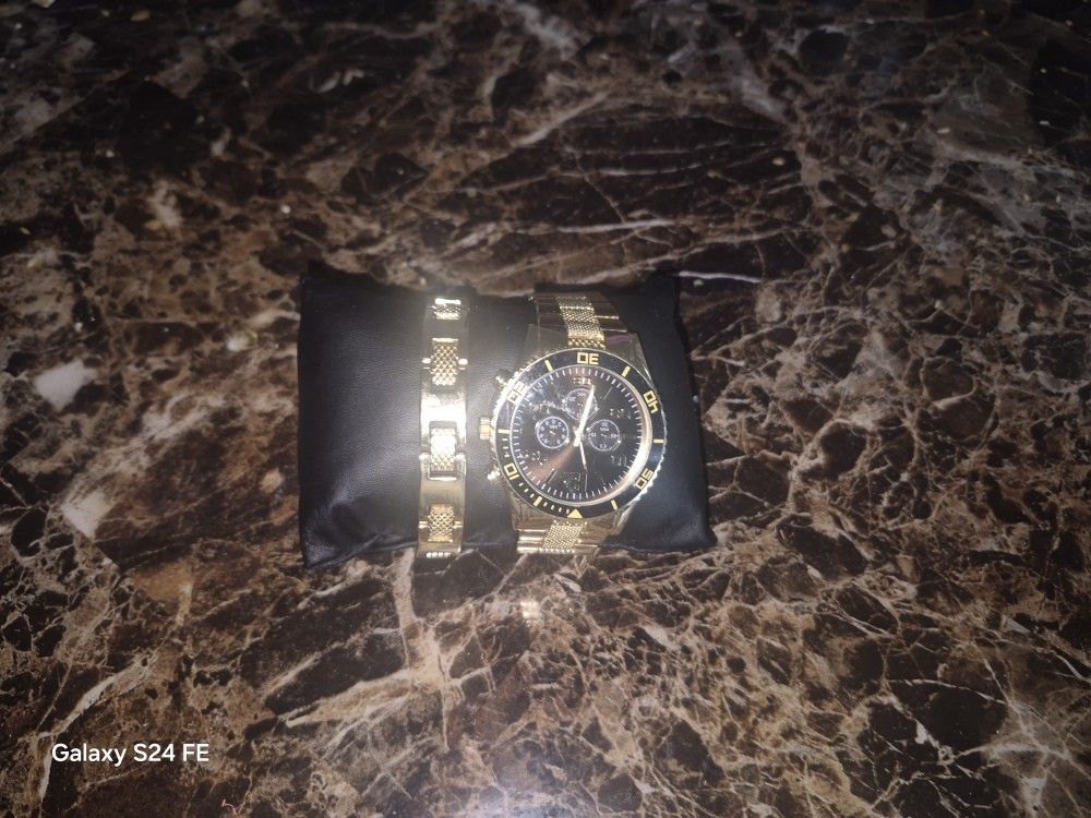 Gold And Black Watch And Bracelet And Charm