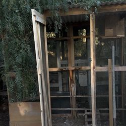 Chain link, wood panels and  catio converted to chicken coop