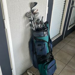 Golf clubs with bag and couple of balls and accessories