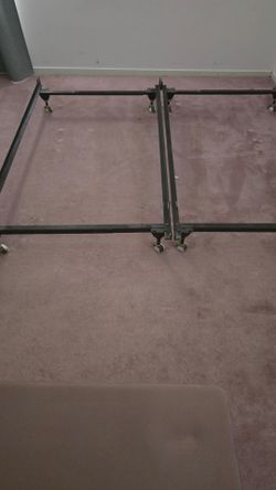 Two adjustable metal bed frames on wheels