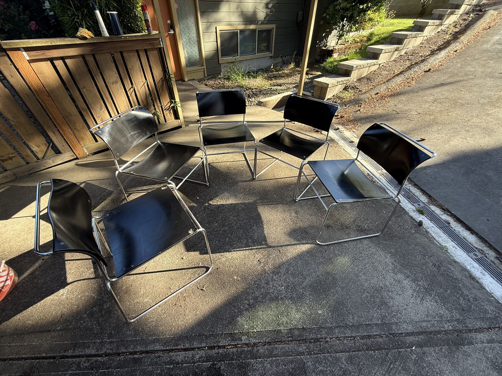 MCM Modern wood and metal stackable chairs. They are dusty but will clean up well. Top wood of chairs has imperfections. Spring cleaning and have not