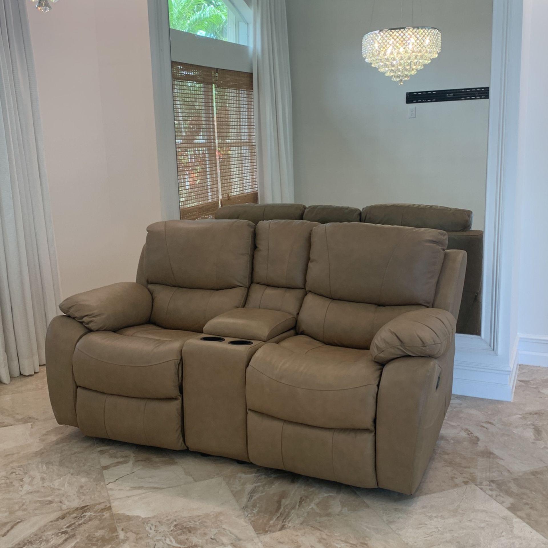 1 Taupe Leather Love Seat Recliner. $250.00 