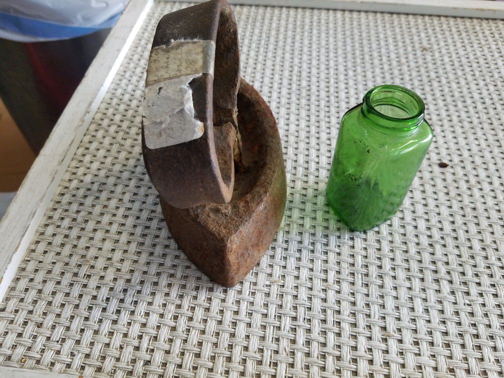 Antique iron and green bottle