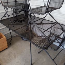 60 x 38 Wrought Iron Table With 4 Chairs That Slightly Rock