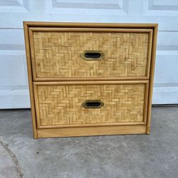 vintage 1980s Boho Chic nightstand featuring a woven herringbone rattan facade and brass-toned handles. Antique, Dresser, Dixie Brand.