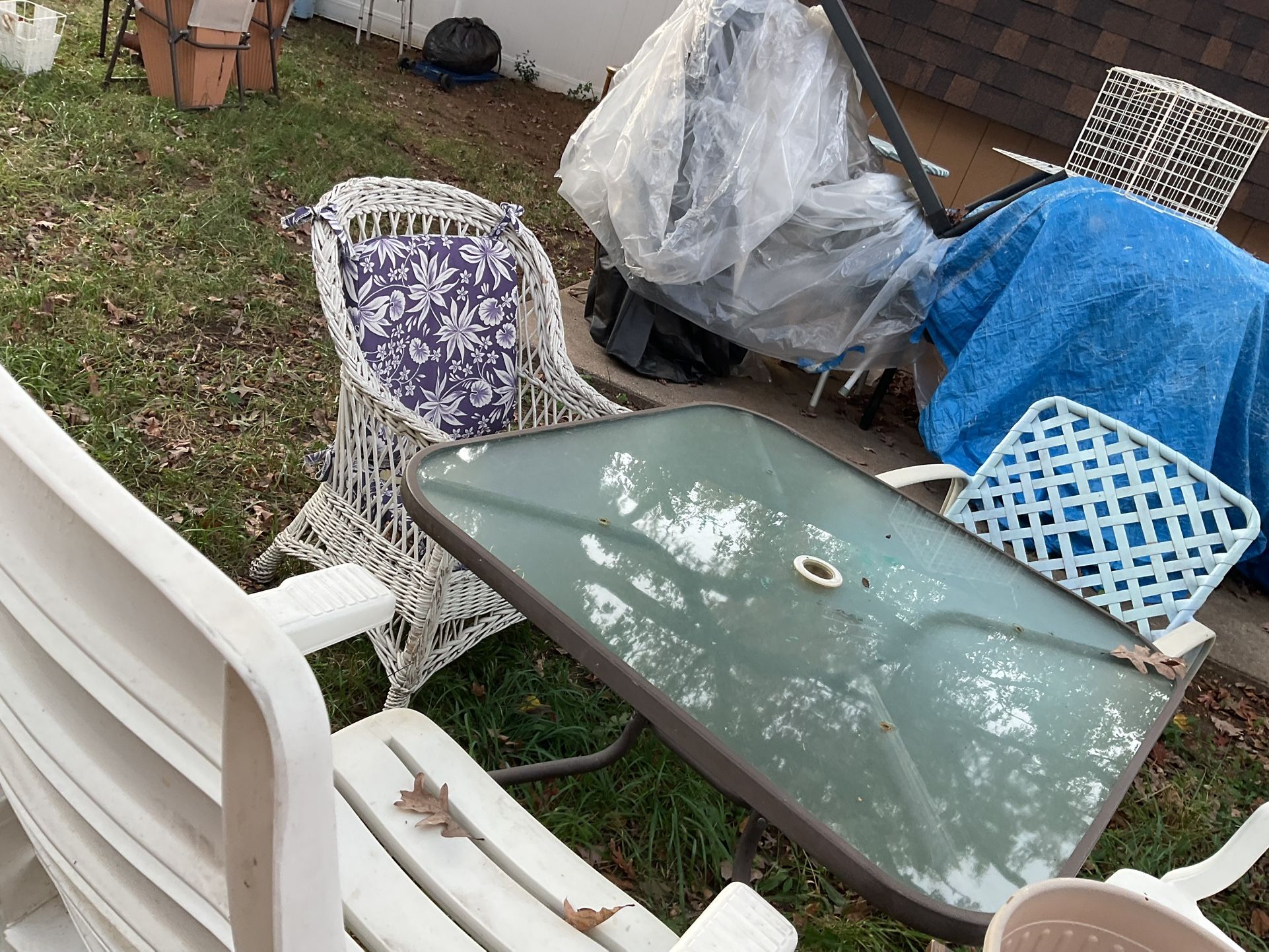 A Set Of Patio Furniture, With A Glass Table, 4 Different Chairs, They Need A Little Cleaning From Being Outside All For $75