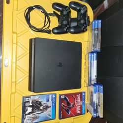 PS4 console with games/controllers/charging dock