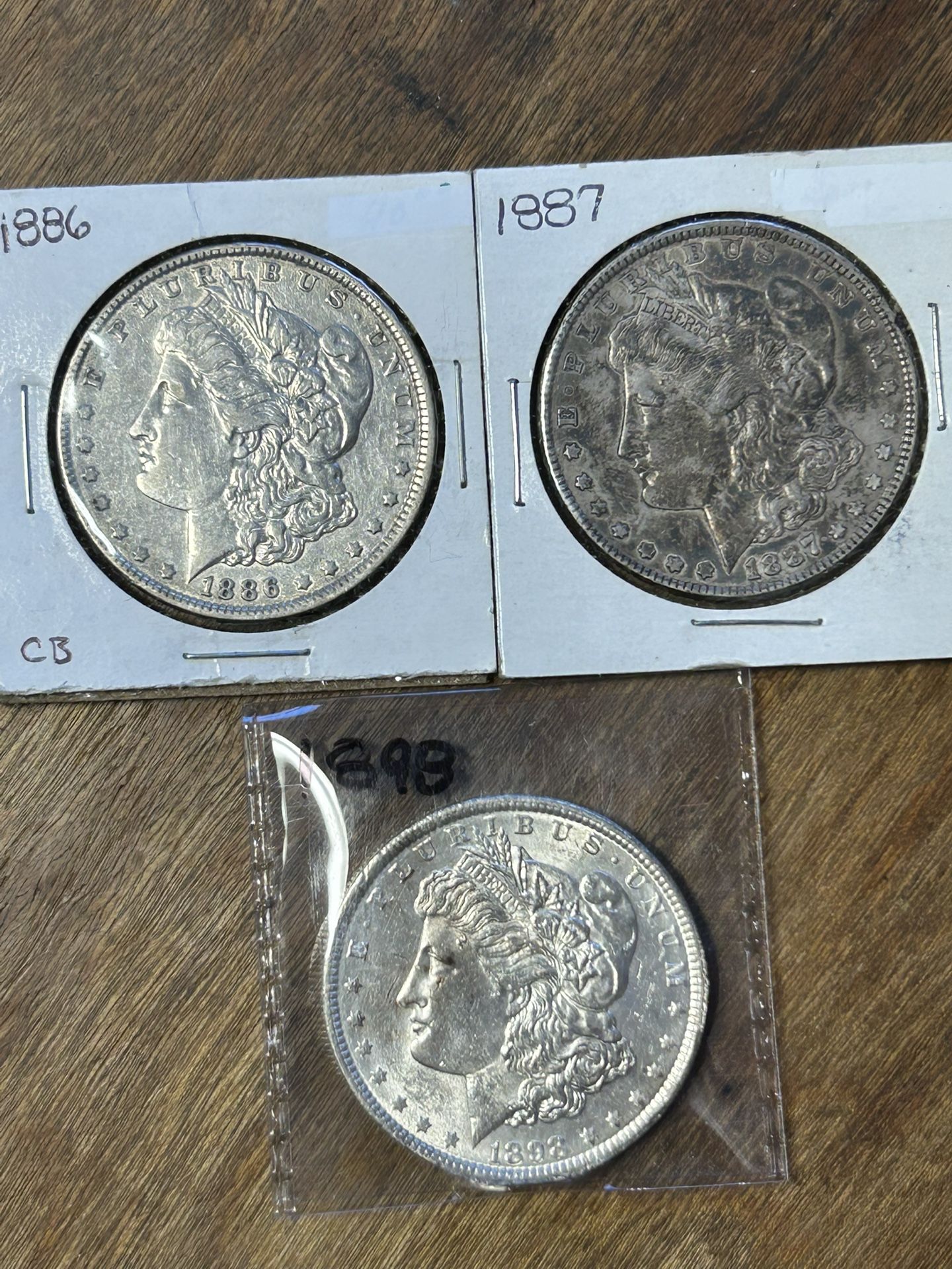 Three Morgan Silver Dollars. Group 25.
