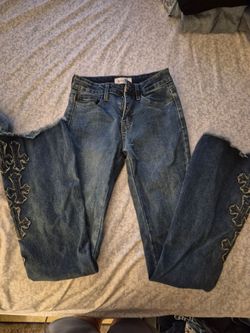 Flared jeans with cross design on the bottom