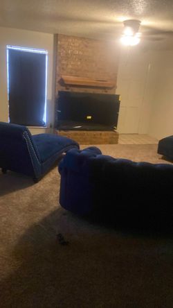Blue velvet sectional and chair with 70” Vizio tv
