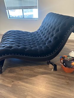 All black tufted chaise lounge