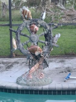 All brass pool fountain ships wheel.