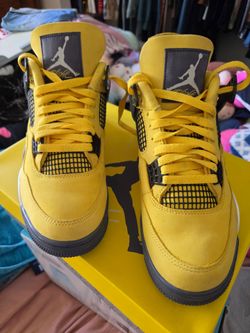 Air Jordan 4 Retro "Lightning" (2021) sneakers featuring a vibrant Tour Yellow nubuck upper and dark blue-grey