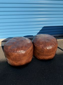 round brown leather poufs