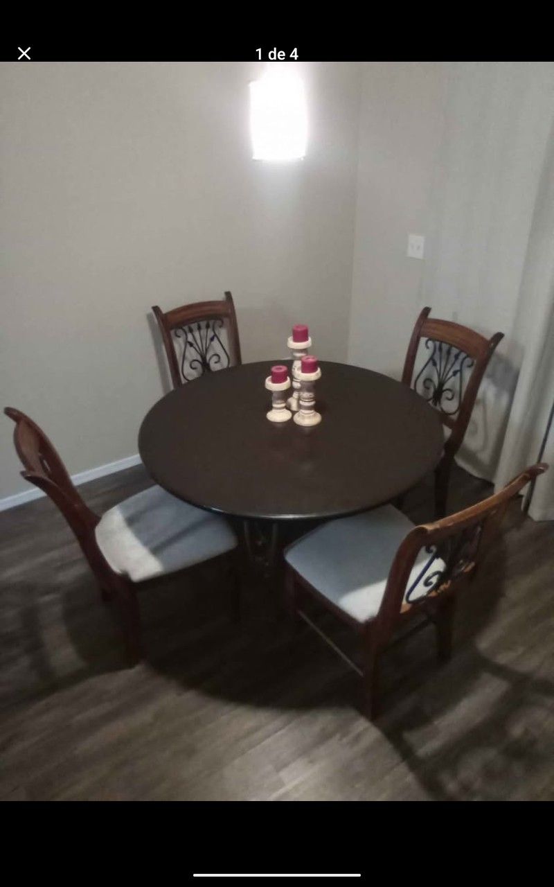 Solid wood dining table with ironwork and 4 chairs.