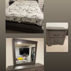 Queen bed with lights, dresser vanity with mirror, and nightstand.