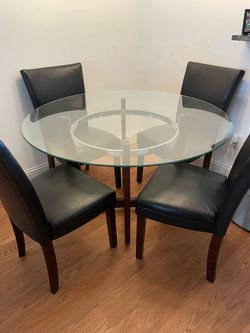 Round glass dining table + 4 black chairs