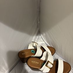 These white wedge sandals are branded as Lottini and were made in Italy.