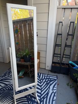 Mirror with jewelry storage